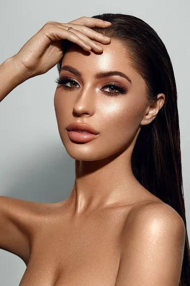 Glamour portrait of a model with long lashes, in a white frame
